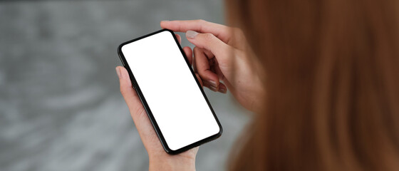Top view Woman sitting and holding blank screen mock up mobile phone