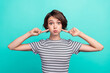 Photo of young girl hold breath fooling point finger cheeks silly isolated over teal color background