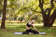 © Ankor_stock. - Young woman in sports uniform doing yoga stretch exercises in the city park.