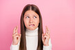 Portrait of attractive unsure uncertain girl praying crossed fingers copy space isolated over pink pastel color background