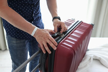Man Closing Suitcase With Combination Lock At Home Closeup