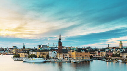 Wall Mural - Stockholm, Sweden. Scenic View Of Stockholm Skyline At Summer Evening. Famous Popular Destination Scenic Place In Dusk Lights. Riddarholm Church In Day To Night Transition Time Lapse