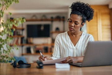 Wall Mural - Focused businesswoman, working from home, and writing