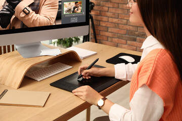 Fototapete - Professional retoucher working on graphic tablet at desk in office