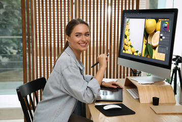 Fototapete - Professional retoucher working on graphic tablet at desk in office