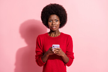 Sticker - Photo of scared young afro american woman hold smartphone addicted user isolated on pink color background