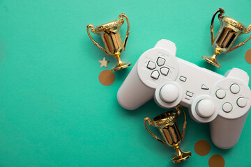 Wall Mural - Video game esports winning competition background. Game controller with gold winning trophy