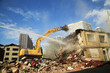 © taylanozgurefe - Excavators working on huge demolition site. Construction machinery demolishing buildings. Building demolition in the city center. Excavators working construction site.