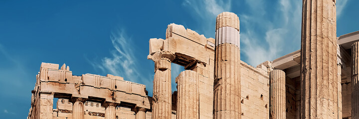 Fototapete - Acropolis fortress in Athens, Greece. Ancient gateway Propylaea, that had been recently reconstructed. Bright day with sunshine, blue sky and feather clouds.