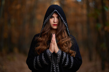 Woman in black dress with hood