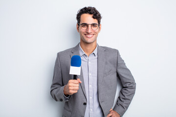 Poster - young handsome man smiling happily with a hand on hip and confident. presenter with microphone