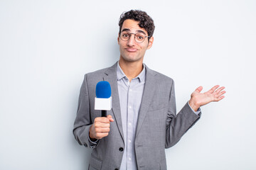 Wall Mural - young handsome man feeling puzzled and confused and doubting. presenter with microphone