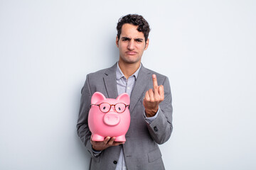 Poster - young handsome man feeling angry, annoyed, rebellious and aggressive. piggy bank concept