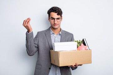 Wall Mural - young handsome man making capice or money gesture, telling you to pay dismissal concept