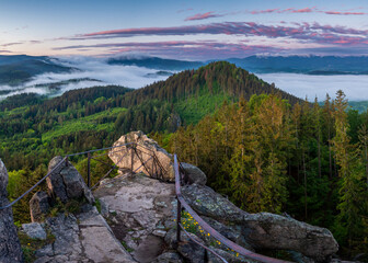 Canvas Print - Beautiful view of greenery-covered hills and mountains from the top of a rocky peak