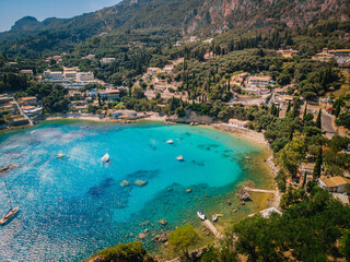 Wall Mural - Aerial view of Paleokastritsa bay on a sunny day. Bay with beautiful turquoise water and boats.