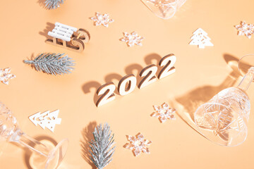 Wall Mural - Festive new year flat lay with numbers 2022 and hard shadows with glasses and shiny decor