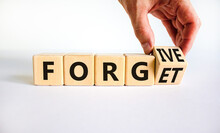 Forgive And Forget Symbol. Businessman Turns A Wooden Cube And Changes The Word Forgive To Forget. Beautiful White Background, Copy Space. Business, Psychological Forgive And Forget Concept.