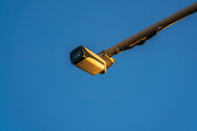 Outdoor Video Surveillance Camera For Traffic On The Highway In The Evening Sun Against The Backdrop Of A Clear Blue Sky
