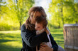 © rubchikova - Young woman holds a baby in her arms outdoor