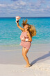 © rubchikova - Happy girl on the beach in a pink boxing gloves