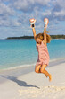 © rubchikova - Happy girl on the beach in a pink boxing gloves
