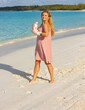 © rubchikova - Happy girl on the beach in a pink boxing gloves