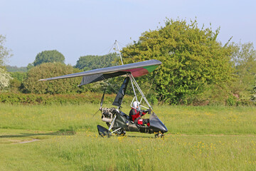 Poster - 	
Ultralight airplane taxiing on a farm strip	