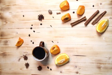 Wall Mural - Cup of fruit coffee with spices on wooden table