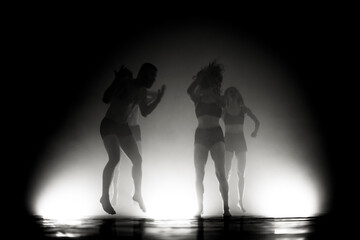 Wall Mural - modern ballet dancers jumping. motion blur and smoke