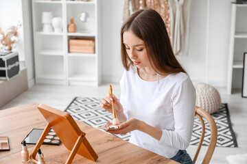 Wall Mural - Pretty young woman with makeup brush and powder at table in dressing room