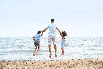 Poster - Little children with father on sea beach