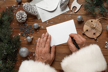 Santa Claus Writing Letter On Wooden Background