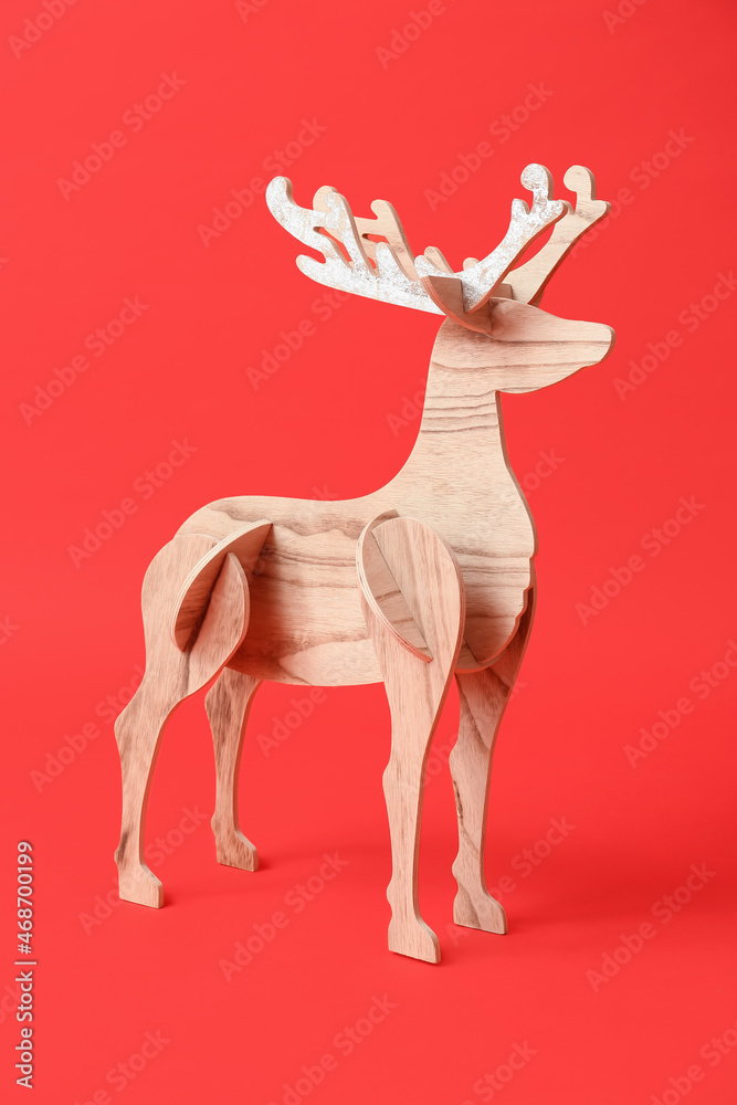 Wooden reindeer on red background