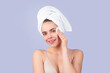© Volodymyr - Portrait of young beautiful woman after bath. Beauty face of a cheerful attractive girl with towel on head, isolated. Moisturized healthy skin, morning spa, beauty routine, facial skincare treatment.