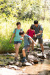 © Blue Jean Images - Happy young family hiking outdoors