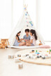 © Blue Jean Images - Cute Chinese children playing in tent