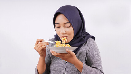 asian girl happily enjoying noodles isolated on white background