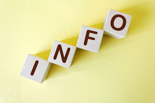 Info word written on wood block. Info text on table, concept.