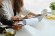 © bongkarn - Cropped image of two colleagues working together