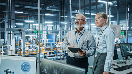 Poster - Car Factory: Female Project Manager Talks to Male Automotive Engineer, Plan Strategy Using Tablet Computer. Automated Robot Arm Assembly Line Production Conveyor Manufacturing Electric Vehicles 