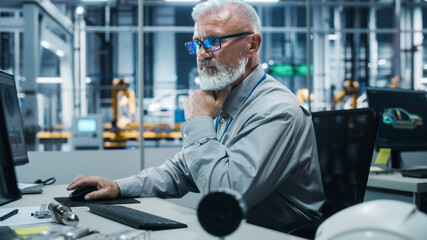 Poster - Car Factory Office: Portrait of White Male Chief Engineer Working on Desktop Computer in Automated Robot Arm Assembly Line Manufacturing High-Tech Electric Vehicles. Electronics Production Conveyor
