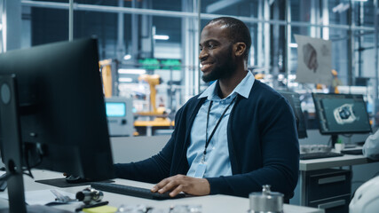 Fototapete - Car Factory Office: Portrait of Confident Black Male Chief Engineer Working on Desktop Computer. Professional Technician in Automated Robot Arm Assembly Line Manufacturing High-Tech Electric Vehicles