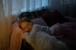 © Анна Молько - a tired child sleeps on an armchair under a pink fluffy blanket. fatigue after study at lockdown