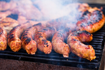 Poster - Grilling sausages and pork chops on the barbecue grill in the garden