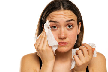 Wall Mural - Young woman cleaning her face with wet wipe