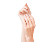 © Yuliya - Female hands with a neat nude manicure isolated on a white background.