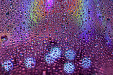 Selective Focus Shot Of Colorful Reflective Water Drops On A Digital Disc Surface
