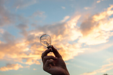 Poster - a person holding a light bulb in their hand (Idea bulb)