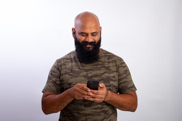 Indian Strong Healthy middle aged bald man with Smart phone & chatting on texting his friends 